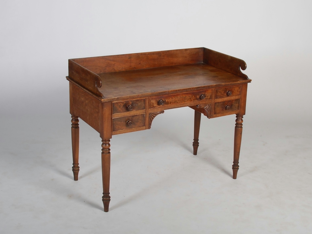 A 19th century mahogany washstand, the rectangular top with raised three quarter gallery above a