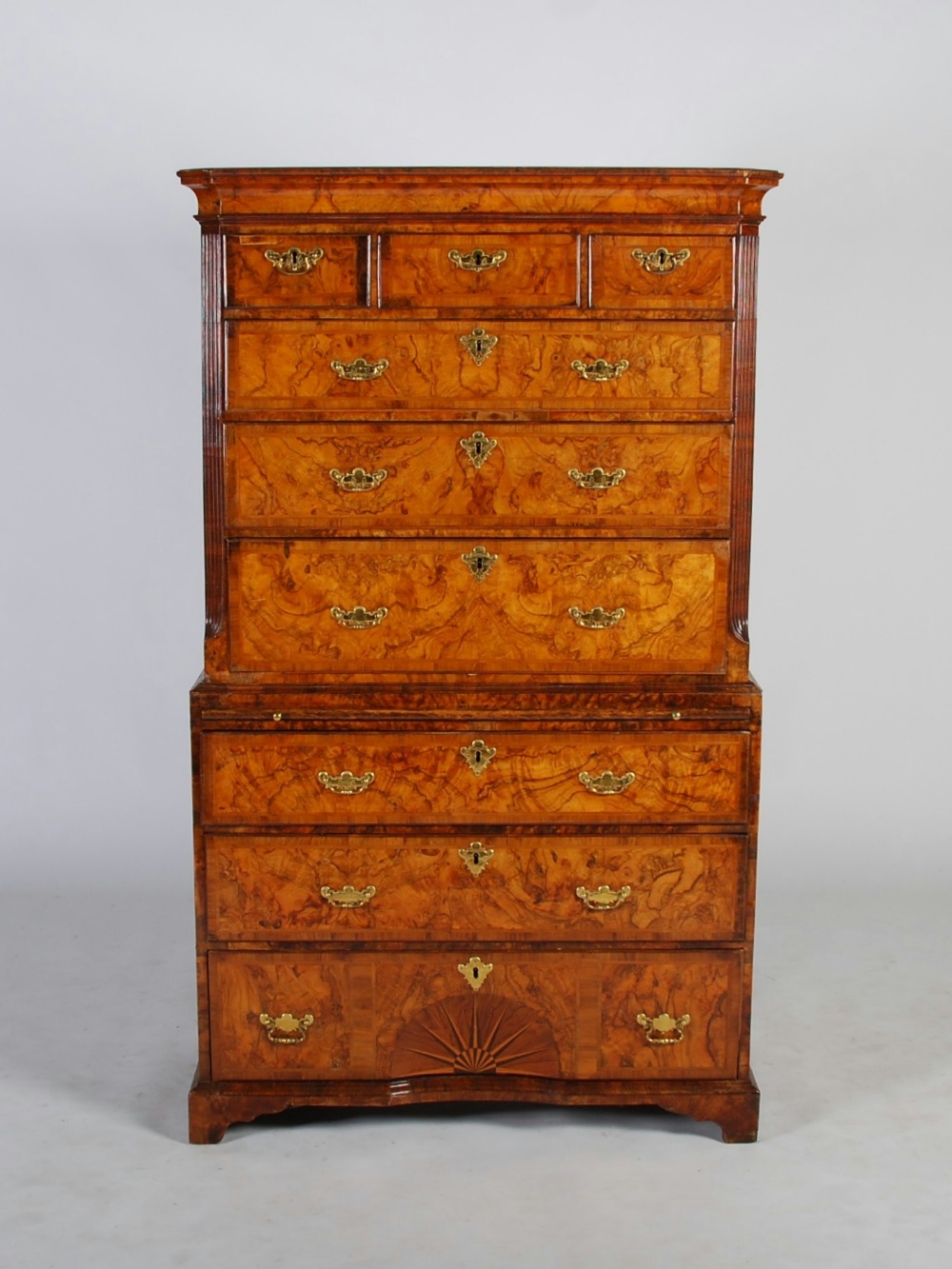 A George II walnut chest on chest, the moulded cornice above three frieze drawers and three long