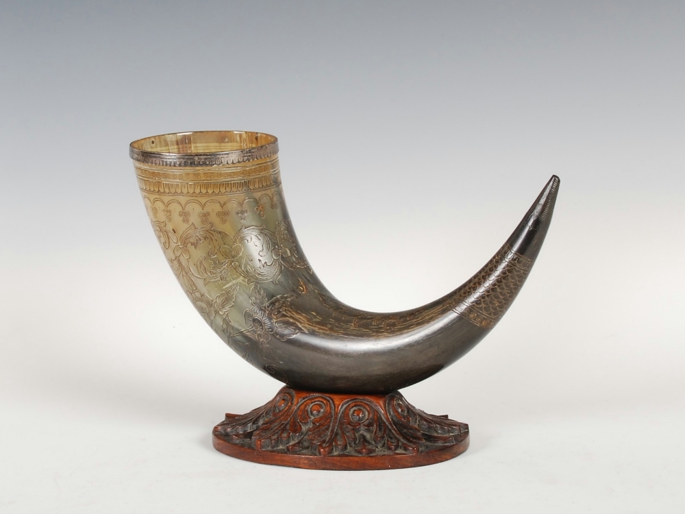 A 19th century white metal mounted horn, with incised bird and floral decoration, the rim with a