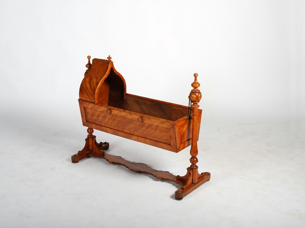 A Victorian satin birch cot, the rectangular top with arched canopy, panelled sides and slatted