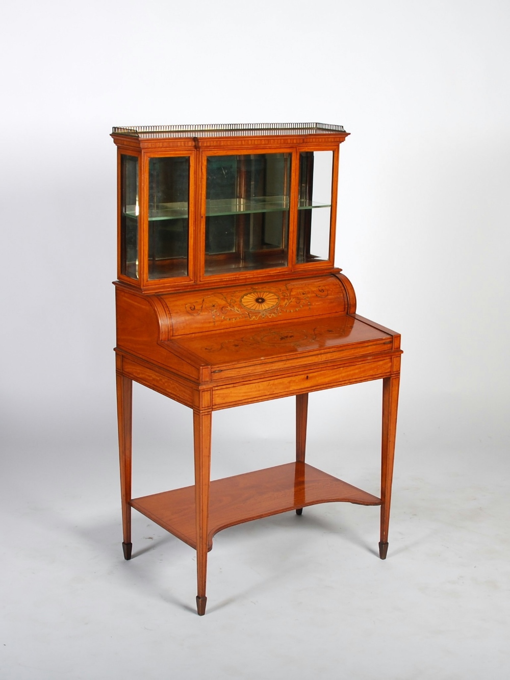An Edwardian satinwood, marquetry and ebony lined writing desk, the upper section with a
