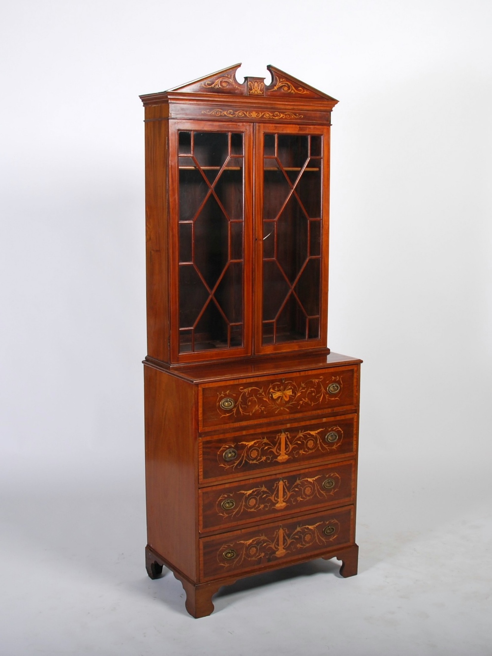 An Edwardian mahogany and satinwood banded secretaire bureau bookcase, the upper section with broken