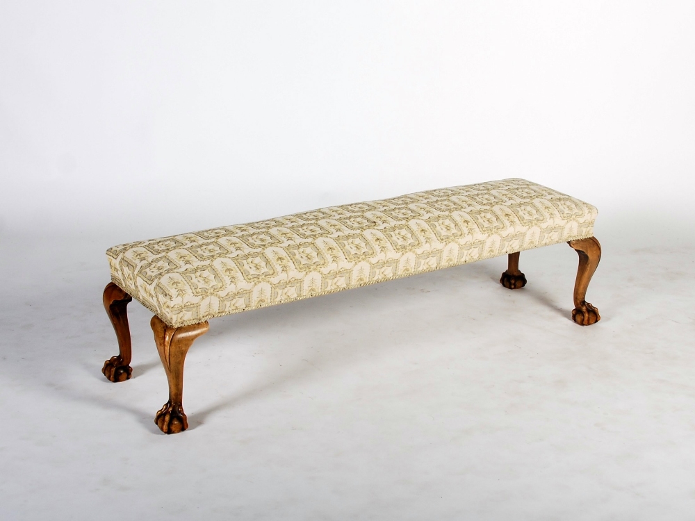 A George III style walnut rectangular stool, the upholstered seat raised on four cabriole legs