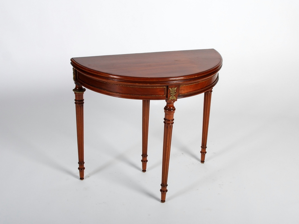 An early 20th century mahogany and gilt metal mounted demi lune card table, the hinged top opening