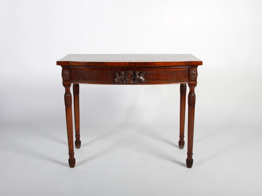 A 20th century George III style mahogany bow front serving table, the shaped top above a fluted