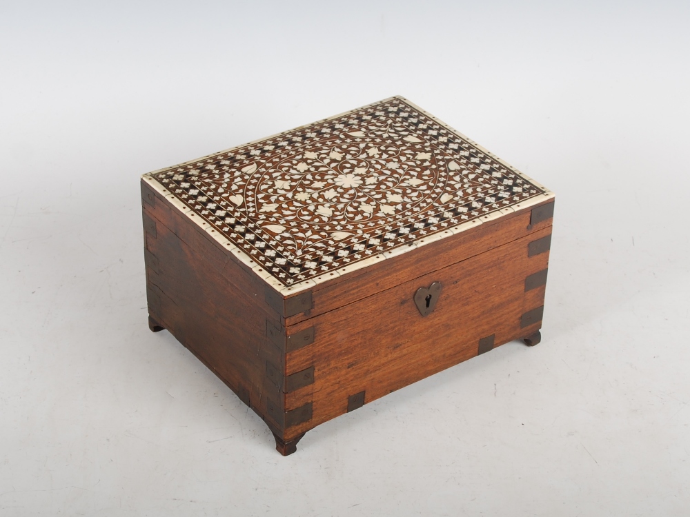 A 19th century Anglo-Indian teak and brass bound ivory and ebony inlaid vanity box, the hinged cover