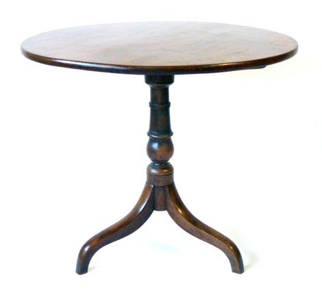 A Georgian mahogany circular tilt top table on turned support and trefoil legs