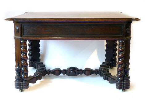 A late Victorian heavily carved oak centre table with single frieze drawer and applied barley