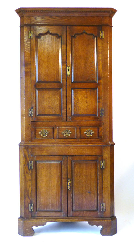 An early 18th century-style free standing oak corner cupboard, w. 97cm CONDITION REPORT: