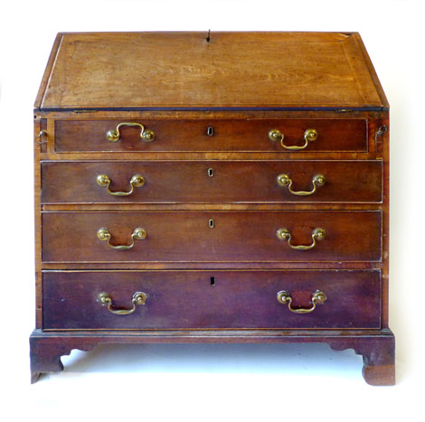 A George III mahogany bureau with fall front and fitted interior over four graduated long drawers on