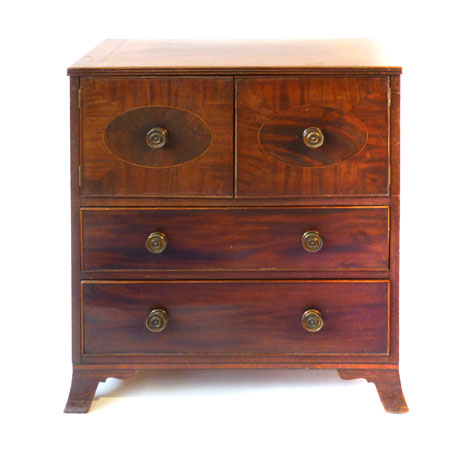 A George III and later mahogany and strung commode enclosed by a pair of doors above two drawers