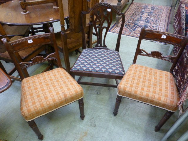 A pair of George III mahogany dining chairs with overstuffed seats together with a Hepplewhite style