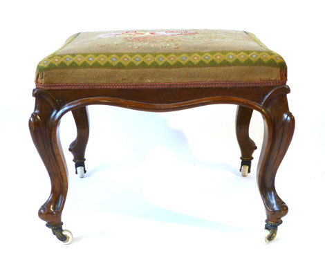 A Victorian walnut framed stool with petit point upholstered top on moulded cabriole legs, 53cm