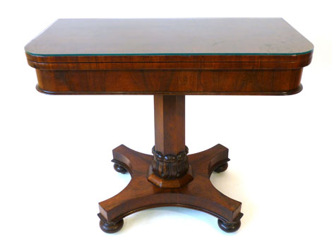 A William IV rosewood and crossbanded fold over top tea table on column support with carved