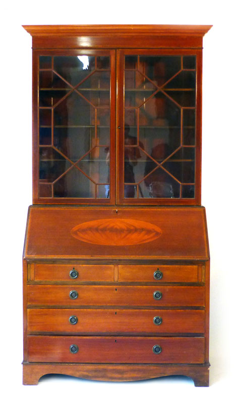 An Edwardian mahogany, strung, crossbanded and inlaid bureau bookcase with three graduated long