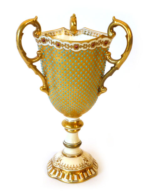 A Coalport three handled porcelain goblet, gilt decorated and enamelled with turquoise "Jewels",