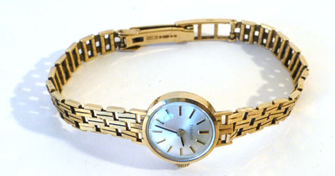 A lady's 9ct gold cased wristwatch by Tissot, having baton numerals on a 9ct gold adjustable key