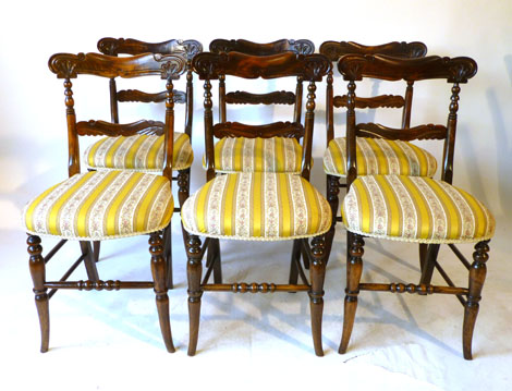 Six Victorian beech parlour chairs with carved bar backs and over stuffed seats on turned tapering