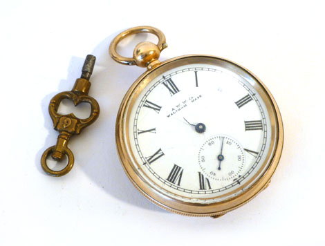 A gold plated open face pocket watch by Waltham, Massachusetts, having black Roman numerals on a