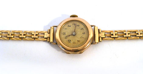 A lady's 9ct gold wristwatch having black Arabic numerals on a gold coloured ground on a 9ct gold