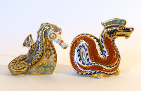 A Royal Crown Derby Imari paperweight coral sEahorse together with dragon, both with gold buttons (