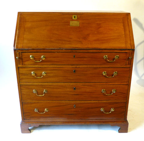 A George III mahogany bureau, fall front with brass plaque engraved 'A.O.F. presented to Bro.J V.