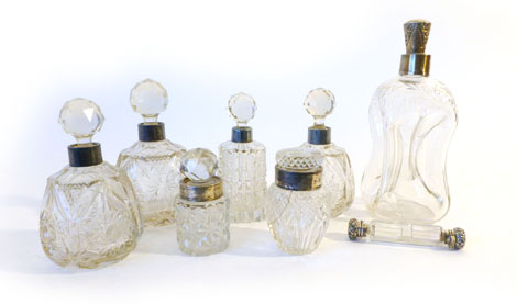 Seven various silver collared scent bottles, jars and a decanter, comprising a pinched decanter with