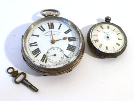 Two open face pocket watches both having Arabic numerals on a white ground