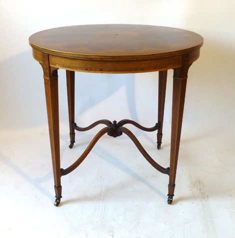 A 19th century inlaid mahogany side table of circular form, the top inlaid with pen worked foliate