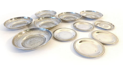 A set of six Eastern white metal dishes or circular form, three with engraved script to centre,