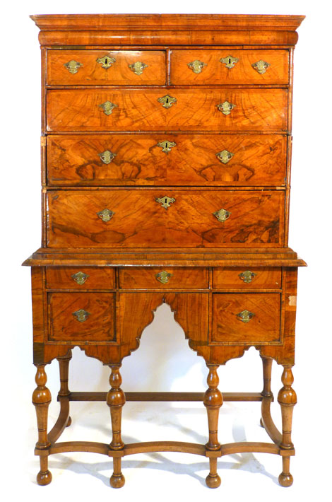 An early 18th century walnut chest on a later Queen Ann style stand, the chest with feather