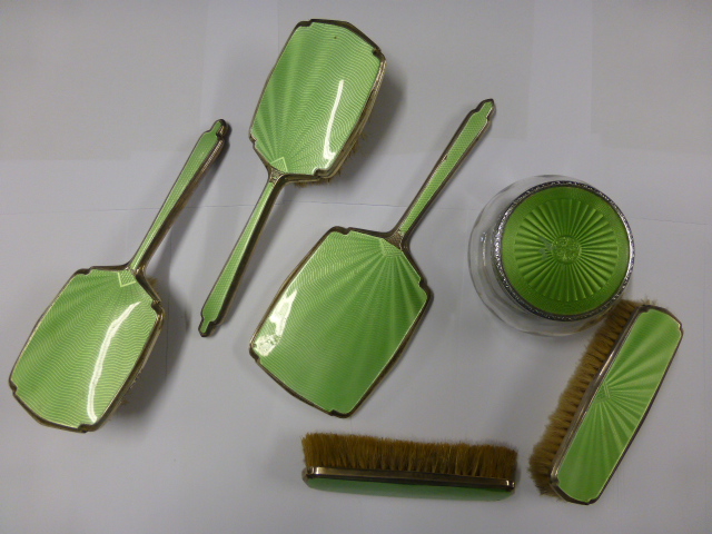 A George VI silver backed part dressing table set with enamelled green guilloche enamelled