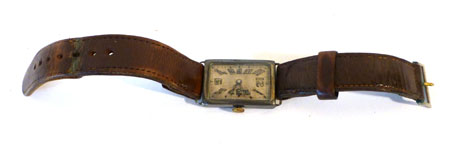 A gentleman's silver cased wristwatch of rectangular form having Arabic numerals on a silver