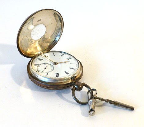 A silver cased half hunter pocket watch having black Roman numerals on a white ground and second