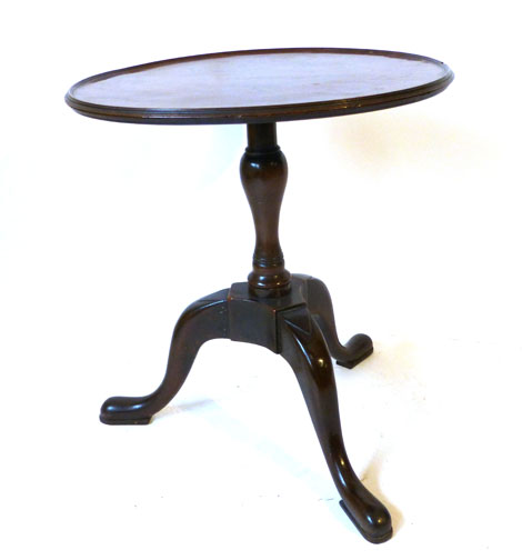 A 19th century mahogany occasional table with circular lipped top on a cut down baluster base on