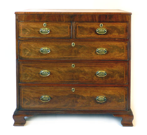 A George III inlaid mahogany chest of two short over three long graduated drawers in two sections on