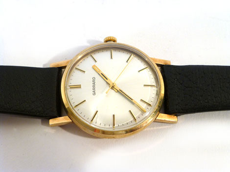 A gentleman's 9ct gold wristwatch by Garrard, movement stamped Garrard 17 Jewels, having gold