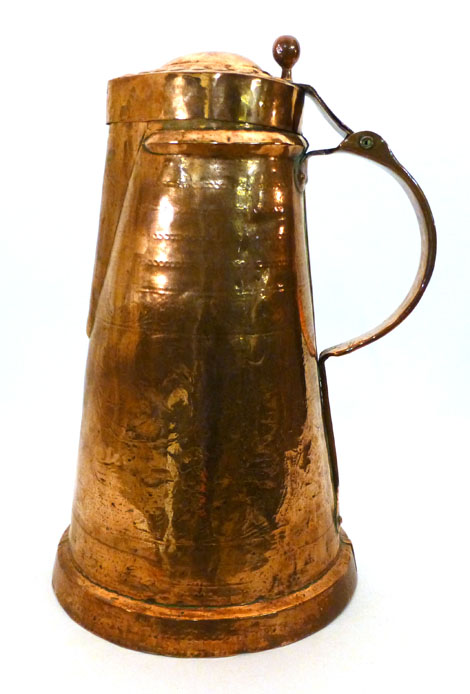 A German/Austrian copper lidded jug of tapered form, the domed lid with a ball shaped thumb piece,