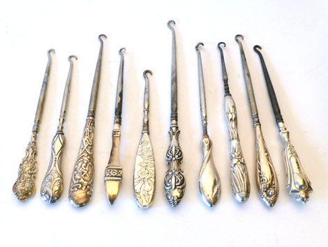 A collection of ten button hooks, nine being silver handled including rococo style, Oriental style