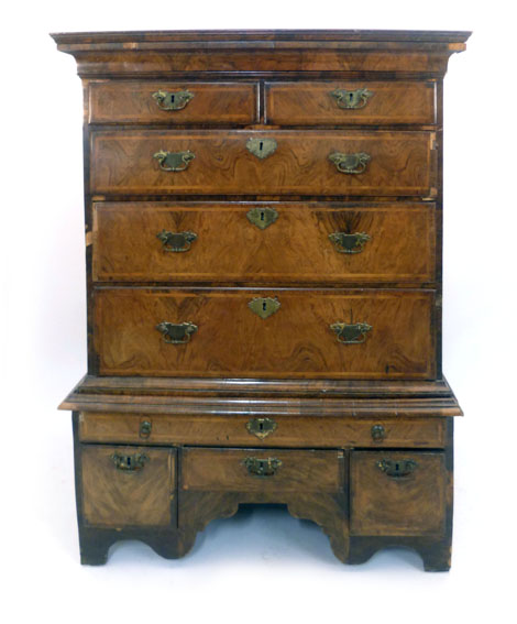 An 18th century style walnut chest on stand, the top with two short and three long graduated