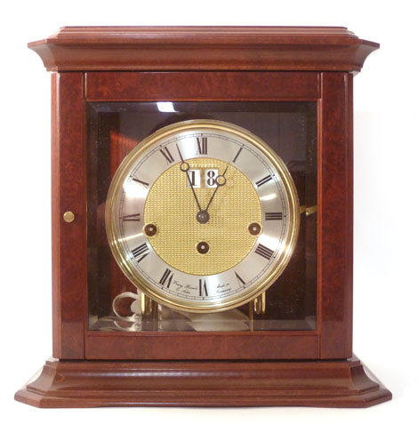 A Frang Hermle mahogany eight day mantel clock, the silvered Roman dial with a date aperture and