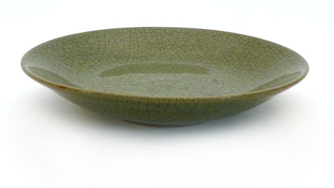 A Chinese crackle glazed dish of circular form on a green ground, 30cm diameter CONDITION REPORT: