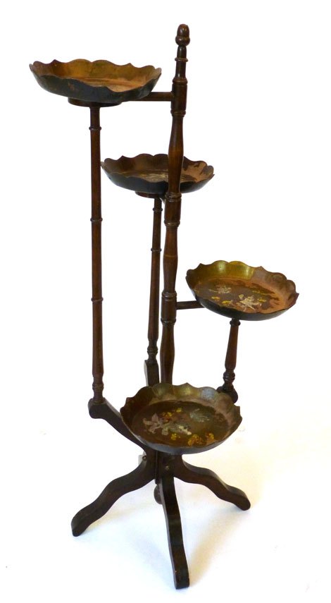 A 18th century style mahogany four tier cake stand with painted papier mache dishes fixed on ring