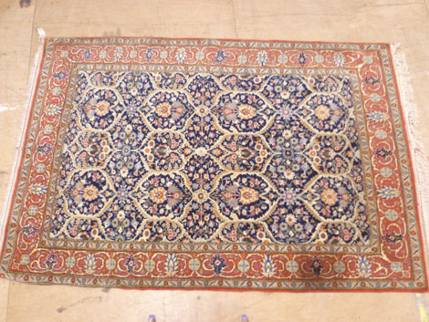 A fine Isfahan rug with multi floral decoration in red, yellow, pink, blue, green and cream on  a