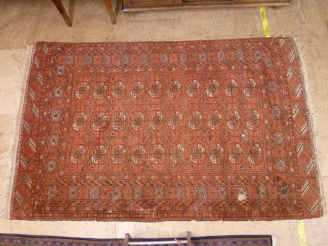 An Afghan rug with thirty gulls within multi borders in cream, brown on a red ground, 231 x 147cm