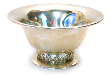 An American silver bowl with a flared rim raised on a pedestal foot with a chased woven style