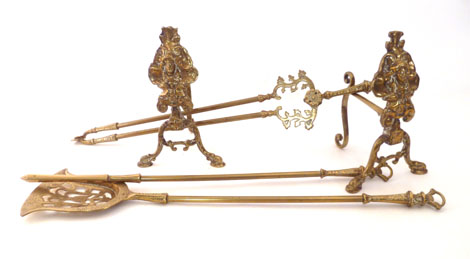 A set of three 18th century style brass fire irons with scroll handles together with a pair of