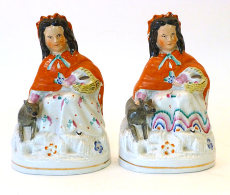 A pair of Staffordshire flat back figures of Little Red Riding Hood, each with a wolf at her side,