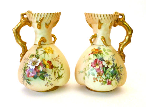 A pair of Royal Worcester blush ware jugs of lobed form each with a gilt handle in the form of coral