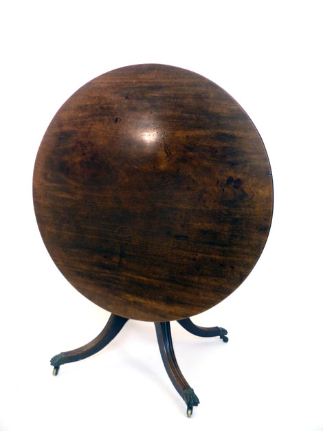 A Regency mahogany circular tilt top breakfast table on a turned column with four reeded outswept